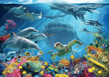 A vibrant 300-piece jigsaw puzzle featuring an underwater scene filled with marine life. Dolphins, turtles, colorful fish, and rays swim among coral reefs, with sunlight filtering through the water above, creating a serene and lively underwater atmosphere.