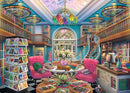 A vibrant illustration of The Book Palace jigsaw puzzle by Ravensburger, showcasing a colorful library with pink chairs, wooden bookshelves, and a spiral staircase. A table with open books and a cat, surrounded by flowers and vibrant decor, offers a cozy reading atmosphere.