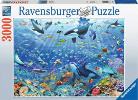 A vibrant jigsaw puzzle box featuring the 'Colorful Underwater World 3000' design by Ravensburger. The image showcases a stunning underwater scene filled with diverse marine life including orcas, colorful fish, and coral reefs. The puzzle is suitable for enthusiasts and families seeking a fun, engaging activity. The packaging highlights the puzzle's 3000-piece count and premium quality.