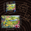 A Ravensburger jigsaw puzzle titled 'WOOD: Nature Garden' featuring a vibrant landscape filled with flowers, a river, and wildlife. The puzzle includes 500 pieces and measures approximately 40 cm x 27 cm when completed. The box dimensions are 22 cm x 22 cm. A visual representation of the puzzle pieces is also shown.