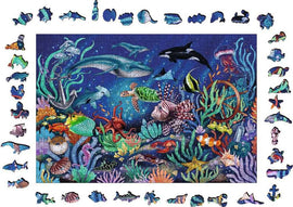 A colorful 500-piece jigsaw puzzle titled 'WOOD: Under the Sea' by Ravensburger. The completed puzzle features an underwater scene filled with various marine life, including fish, turtles, sharks, and coral, set against a deep blue ocean background. The puzzle pieces showcase detailed illustrations of sea creatures and underwater elements, making it a vibrant and engaging visual experience.