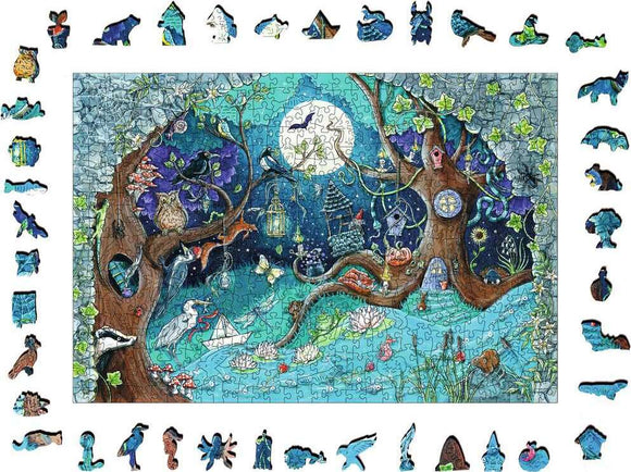 A colorful 500-piece jigsaw puzzle titled 'Fantasy Forest' by Ravensburger, featuring an enchanting woodland scene with whimsical characters, a large tree, and hidden treasures under a glowing moon. The puzzle pieces include various animal shapes and details, enhancing the magical forest theme.