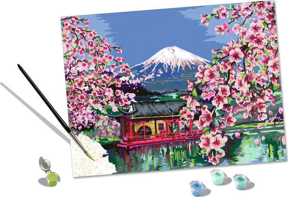 CreArt Japanese Cherry Blossom DIY kit featuring a vibrant image of cherry blossoms in front of a traditional Japanese building and Mt. Fuji in the background. The kit includes a paintbrush, paint pots in various colors, and a pre-printed canvas, making it ideal for art enthusiasts and DIY lovers.