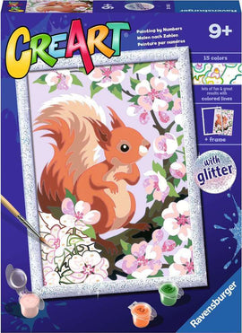 CreArt Spring Squirrel DIY kit featuring a charming painting by numbers design of a cute squirrel surrounded by blooming flowers. The kit includes 15 vibrant colors of paint with a brush and is adorned with glitter for a sparkling finish. Perfect for ages 9 and up, this creative project invites children and adults to express their artistic side while enjoying a fun and engaging activity.
