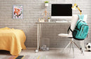 A cozy workspace featuring the CreArt Spring Squirrel DIY kit framed on the wall, set against a backdrop of soft yellow bedding and a modern desk with a computer. The desk is adorned with a small plant and a decorative figure, creating a vibrant and inviting atmosphere.