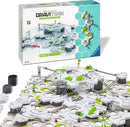 The GraviTrax Theme Set: Balance by Ravensburger features an interactive track system with a variety of innovative terrain pieces and balancing components. The set includes colorful marbles and connectors, allowing for creative construction and gravity-driven gameplay. The packaging is visibly displayed in the background, showcasing the engaging and educational nature of the product.