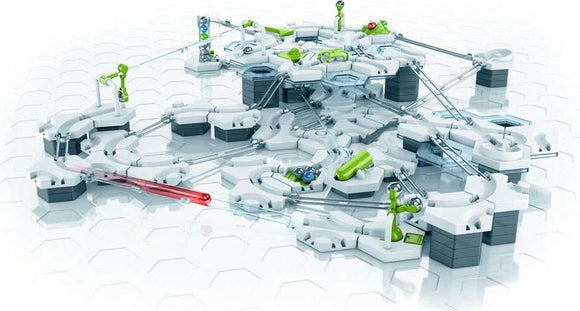 The GraviTrax Theme Set: Balance features a complex layout of modular track pieces, including various connectors, launchers, and action elements. The set is designed with a combination of white and bright green parts, showcasing pathways and ramps for marbles. It promotes STEM learning through interactive play, allowing users to build their own marble run with balancing components.