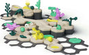 A colorful GraviTrax Junior Starter-Set Jungle by Ravensburger featuring various track pieces, green trees, flowers, and playful animals, designed for creative building and STEM learning.
