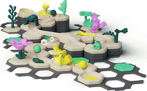 A colorful GraviTrax Junior Starter-Set Jungle by Ravensburger featuring various track pieces, green trees, flowers, and playful animals, designed for creative building and STEM learning.