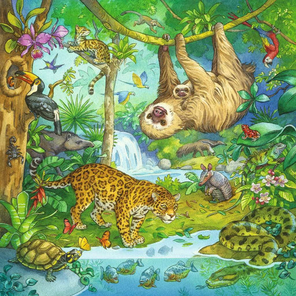 A vibrant jigsaw puzzle illustration titled 'Jungle Fun' by Ravensburger, showcasing a diverse array of jungle animals. Featured are a sloth hanging from a branch with a baby sloth, a jaguar walking on the ground, a turtle by the water, and various birds and insects. Lush greenery envelops the scene, emphasizing the rich biodiversity of a jungle ecosystem.