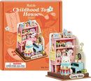 A colorful DIY Childhood Toy House kit by Robotime, featuring a charming miniature interior complete with a polar bear figure, shelves filled with toys, and vibrant decorations. The product is displayed alongside the packaging, which features playful graphics and clear labeling. Perfect for creative play and imaginative building.