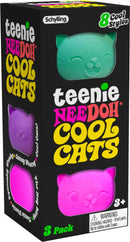 Teenie Cool Cat Nee Doh, a pack of three colorful, squishy cat-themed fidget toys by Schylling. Each toy features a different cat design in vibrant pastel colors including pink, green, and purple. The packaging showcases playful graphics and indicates that there are 8 styles available. A warning label on the side suggests that the product is not suitable for children under 3 years due to small parts.