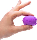 A hand holding a small, purple, squishy toy shaped like a dog. The toy features a cute design with closed eyes and a smiling mouth, ideal for stress relief and sensory play.
