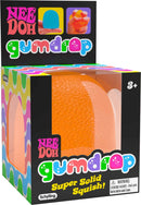 The Nee Doh Gumdrop by Schylling features a vibrant orange squishy toy displayed in its colorful packaging. The box showcases images of hands interacting with the product, emphasizing its soft, tactile feel. It's designed for ages 3 and up, promoting sensory play and relaxation.