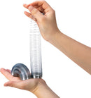 A Mini Sproing toy by Schylling being held in two hands. The toy is a shiny metal spring, partially coiled and partially extended, showing its flexible design. One hand supports a small curled section of the spring while the other hand lifts the elongated section, demonstrating its ability to stretch and compress for fun and engaging play.