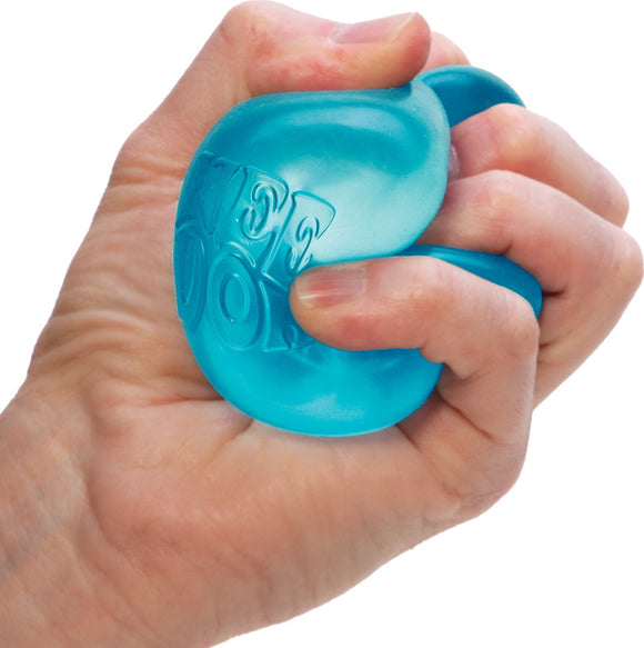A hand squeezing a bright blue Nice Cube NEE DOH fidget toy. The silicone material is soft and squishy, perfect for relieving stress and promoting sensory play.