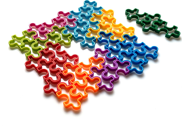 IQ Jigsaw puzzle featuring colorful, interlocking pieces in vibrant hues of red, green, blue, yellow, and purple laid out on a white background. The pieces have unique shapes that fit together to form a larger design, showcasing the creativity and fun of puzzle-solving.