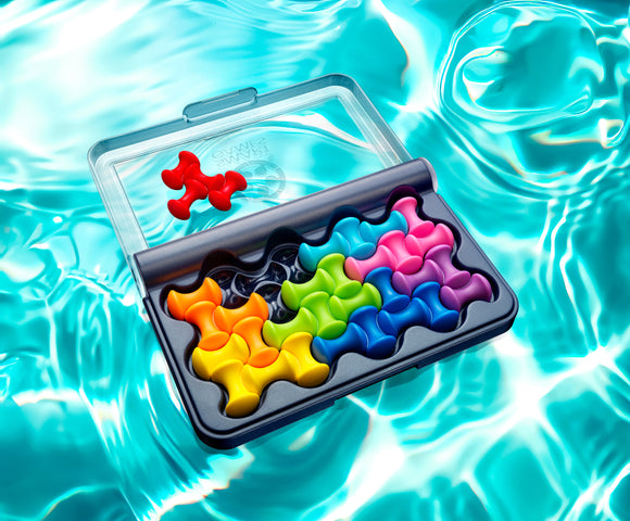 The IQ Waves mechanical puzzle from Smart Toys & Games features interlocking colorful pieces in a clear packaging. The puzzle demonstrates vibrant hues of red, orange, green, blue, pink, and purple, set against an aqua background, showcasing its engaging design aimed at providing hours of critical thinking and entertainment.