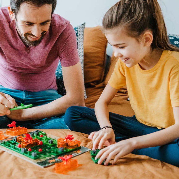 Two people playing SmartGames Dragon Inferno