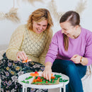 Two people playing SmartGames Dragon Inferno