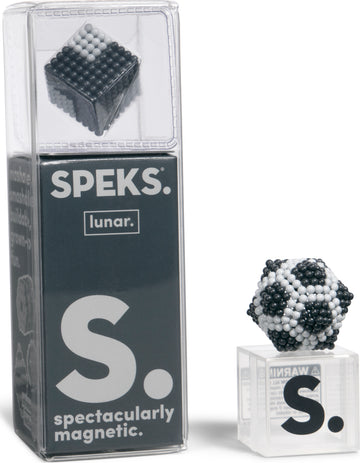 The Speks Elements: Lunar product showcases a magnetic fidget toy set, featuring a cube and a spherical shape made from small black, white, and grey spheres. The packaging is clear, highlighting the unique designs and the 'spectacularly magnetic' branding.