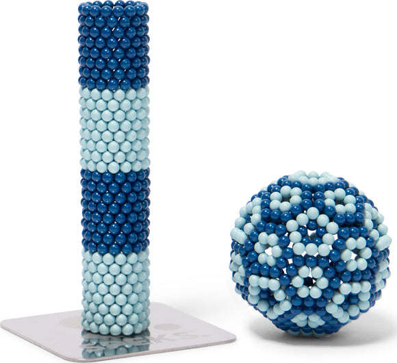 Speks Elements: Zephyr showcases a beautiful assortment of blue and light blue magnetic balls. One is a tall column, while the other is a spherical shape featuring intricate patterns. This engaging item stimulates creativity and provides a tactile experience, perfect for stress relief and distraction.