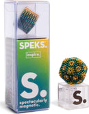 The Speks Inspire Gradient is a colorful magnetic ball toy, featuring vibrant beads in shades of green, gold, and blue. The packaging showcases the product name and highlights its spectacular magnetic properties, ideal for stress relief and creative play. A smaller geometric shape made of the same magnetic beads is displayed next to the box, emphasizing the versatility of the toy.