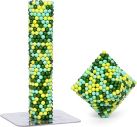 The Speks Pixel Motherboard is a vibrant and colorful magnetic building set, featuring a tall column and a cube made of multicolored spheres in shades of green, yellow, and blue. It encourages creativity and offers endless design possibilities.