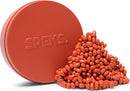 Crags Matte in Coral by SPEKS features a round, vibrant coral container with the SPEKS logo, overflowing with assorted matte coral beads in various shapes and sizes, ideal for sensory play and creativity.