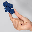 A person demonstrates the Speks Geode: Space Cadet, a fidget toy consisting of interconnected hexagonal magnets, balanced elegantly on their fingertip. The toy features a stylish navy blue design with contrasting blue accents, perfect for stress relief and endless creativity.