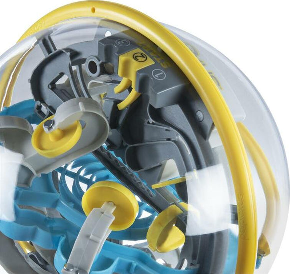 Close-up view of the Perplexus Beast, a mechanical puzzle featuring a clear plastic sphere that houses intricate pathways and obstacles. Colorful blue, gray, and yellow components create an engaging maze for players to navigate a small marble through.