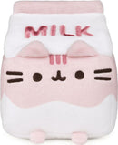 A soft plush toy of Pusheen styled as a strawberry milk carton. The plush features a pink and white color scheme, with the word 'MILK' embroidered on the front. Pusheen's face is adorably represented with whiskers and a small smile, accompanied by rounded ears on top.