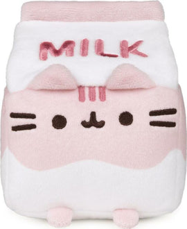 A soft plush toy of Pusheen styled as a strawberry milk carton. The plush features a pink and white color scheme, with the word 'MILK' embroidered on the front. Pusheen's face is adorably represented with whiskers and a small smile, accompanied by rounded ears on top.