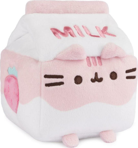 Pusheen Strawberry Milk Sip Plush by GUND, featuring a cute block-shaped plush resembling a milk carton, with a pink and white color scheme, strawberry graphic, and embroidered 'MILK' text.