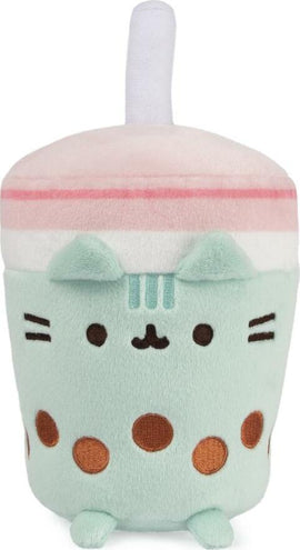 Pusheen Boba Tea Sip Plush by GUND features an adorable plush design resembling a boba tea cup. The plush has a mint green body, pink and white lid with a straw, and cute facial features, along with brown polka dots for a fun touch. Perfect for Pusheen fans and collectors, this soft toy is ideal for cuddling or as a decorative piece.
