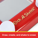 Close-up of the Pocket Etch A Sketch 2023 with a bright red frame and white knobs. The iconic screen is framed by a gold logo, inviting you to draw and create. Below is a caption that reads 'Draw, create, and shake to erase.'