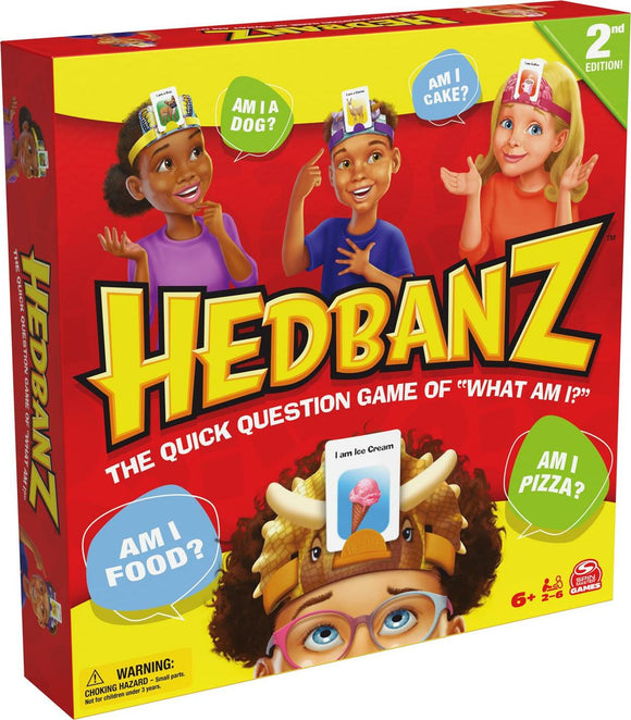 Hedbanz 2nd Edition game box featuring children wearing headbands with question cards. The box showcases vibrant colors, fun illustrations, and engaging phrases like 'Am I a Dog?' and 'Am I Cake?'. Perfect for family game nights.
