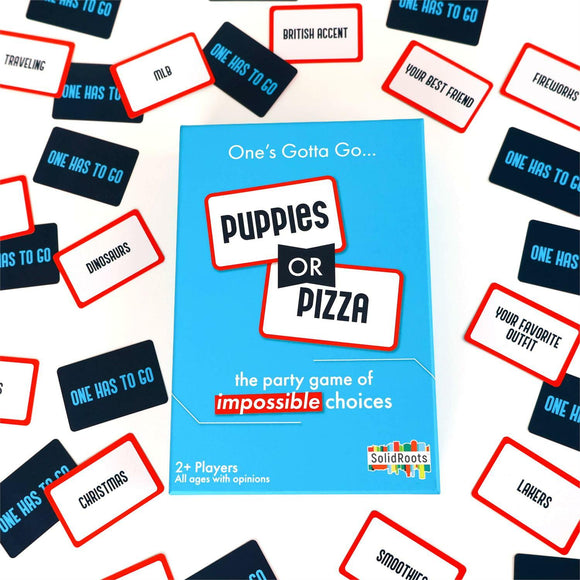 The Puppies or Pizza Game by Solid Roots showcased with its colorful box and game cards spread out. The game features fun prompts challenging players to choose between two amusing options like 'puppies' or 'pizza'. Ideal for 2 or more players, this party game invites laughter and discussion among friends and family.