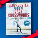 The Blockbuster Book of Easy Crosswords features a colorful cover with the title prominently displayed. A person is humorously holding the book open above their head, surrounded by a crossword puzzle theme. The cover mentions '300 puzzles on perforated pages,' highlighting its accessibility and fun.