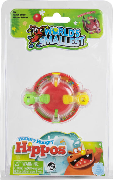 A package featuring the World's Smallest Hungry Hungry Hippos game by Super Impulse. The game is a miniature version of the classic marble-chomping game, depicted with colorful graphics and featuring a red and yellow game piece. Clear plastic packaging allows visibility of the game inside, which includes small hippo characters and a fun, playful design.