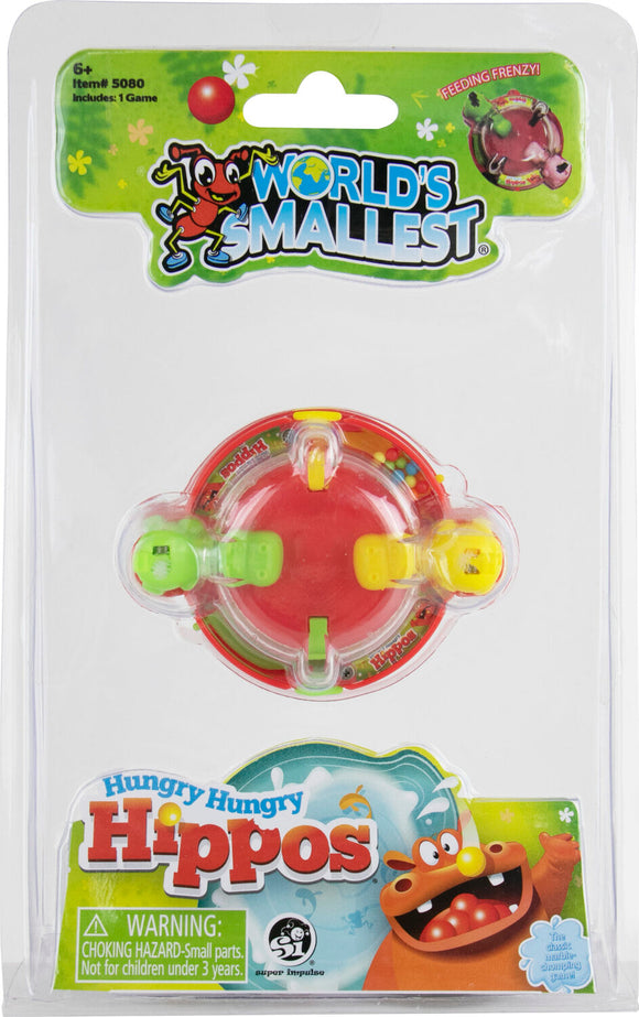 A package featuring the World's Smallest Hungry Hungry Hippos game by Super Impulse. The game is a miniature version of the classic marble-chomping game, depicted with colorful graphics and featuring a red and yellow game piece. Clear plastic packaging allows visibility of the game inside, which includes small hippo characters and a fun, playful design.