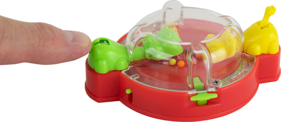 World's Smallest Hungry Hungry Hippos game featuring a vibrant red base with yellow and green hippos. A finger is pressing down on the game, activating it. The hippos are ready to chomp, surrounded by colorful marbles in a playful, compact design.