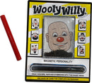 The World's Smallest WoolyWilly by Super Impulse features a playful magnetic drawing board with a cartoon character's face. A red magnetic wand is included for creating hair, mustaches, and eyebrows using fine metal shavings. The packaging displays colorful instructions and various face designs, making it an entertaining fidget toy for all ages.