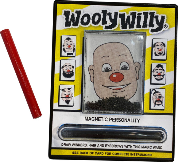 The World's Smallest WoolyWilly by Super Impulse features a playful magnetic drawing board with a cartoon character's face. A red magnetic wand is included for creating hair, mustaches, and eyebrows using fine metal shavings. The packaging displays colorful instructions and various face designs, making it an entertaining fidget toy for all ages.