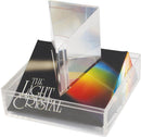A 2.5-inch light crystal prism displayed on a vibrant, multicolored base. The prism captures and refracts light, casting colorful patterns, perfect for educational purposes or as a decorative piece.