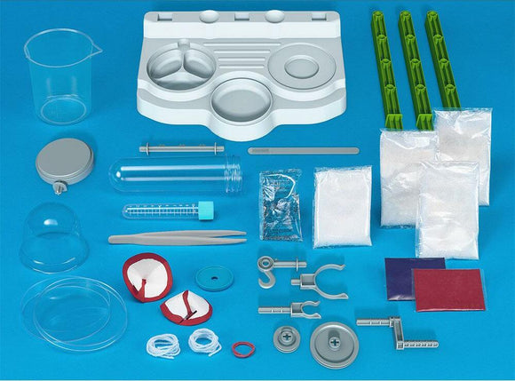 Ooze Labs: Colorful Crystal Lab DIY kit from Thames & Kosmos featuring various equipment and materials. Includes test tubes, beakers, measuring spoons, and colorful powders for creating crystal formations. Ideal for hands-on science experiments and creativity.