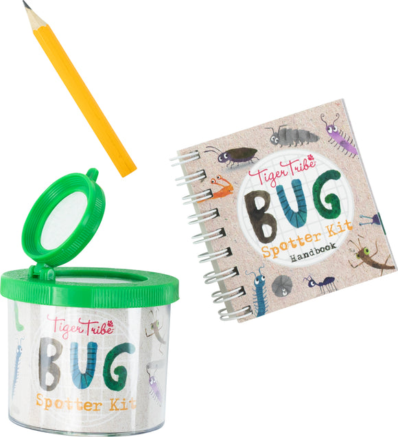 Tiger Tribe Bug Spotter Kit featuring a green observation container, a yellow pencil, and a spiral-bound handbook decorated with various bug illustrations. The kit is designed for children to explore and learn about insects and nature.