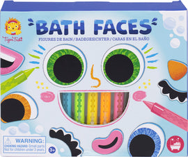 The packaging for Bath Faces by Tiger Tribe features colorful and whimsical face parts including large googly eyes, a smile, and various features like noses and eyebrows, along with brightly colored markers for customization. It's designed for fun in the bath, appealing to children with its cheerful design.