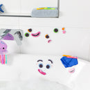 A colorful set of bath face stickers arranged in a playful manner on a white tiled bathroom wall and bathtub. The stickers include various eyes, mouths, and facial features, inviting creativity and fun during bath time. Nearby, there are colorful bath crayons and a plush octopus toy.