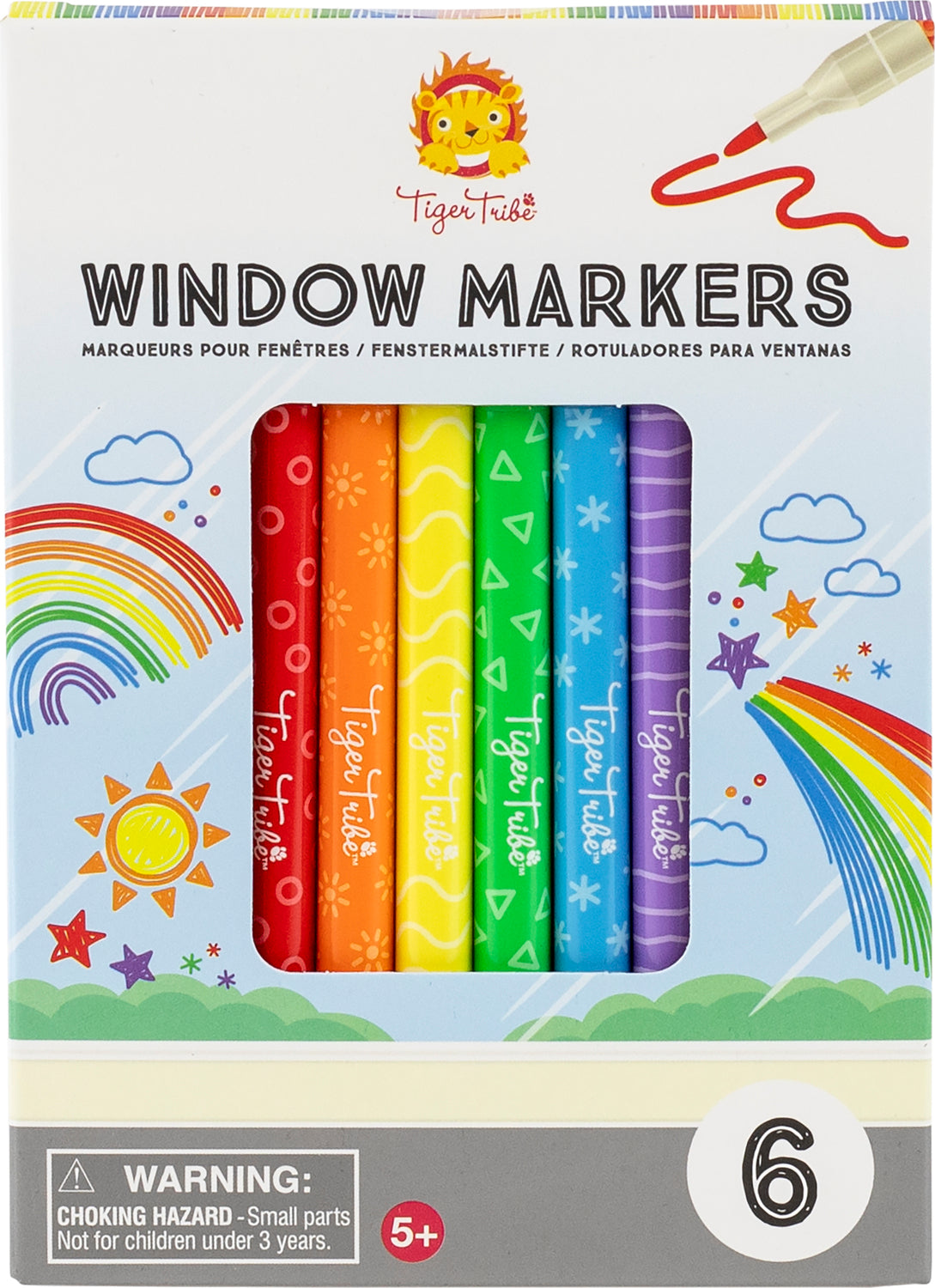 A colorful set of window markers by Tiger Tribe, featuring six vibrant colors including red, orange, yellow, green, blue, and purple. The packaging highlights playful designs like clouds, stars, and a rainbow, making it ideal for fun art projects and decorations.